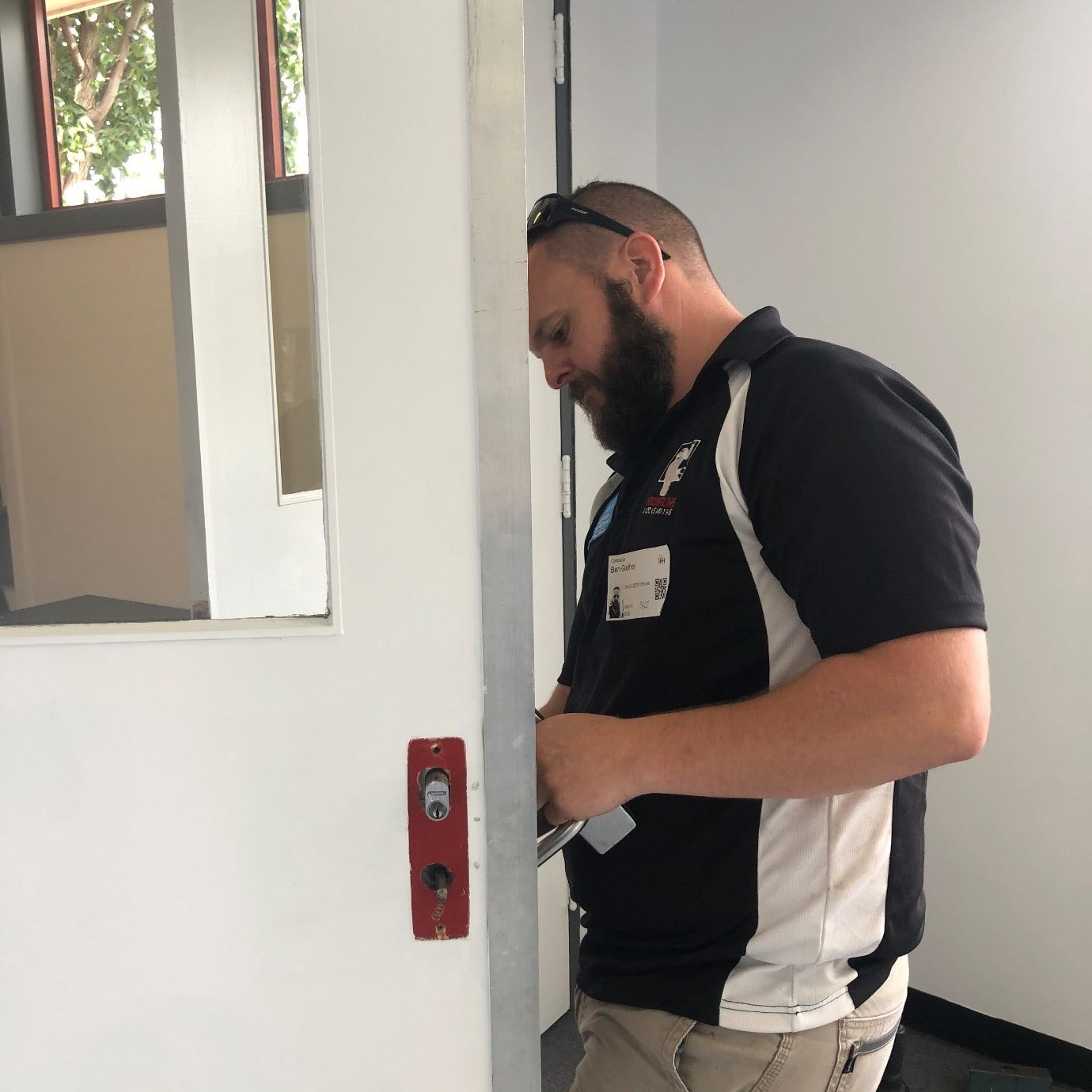 licensed locksmith Melbourne checking door lock professionally
