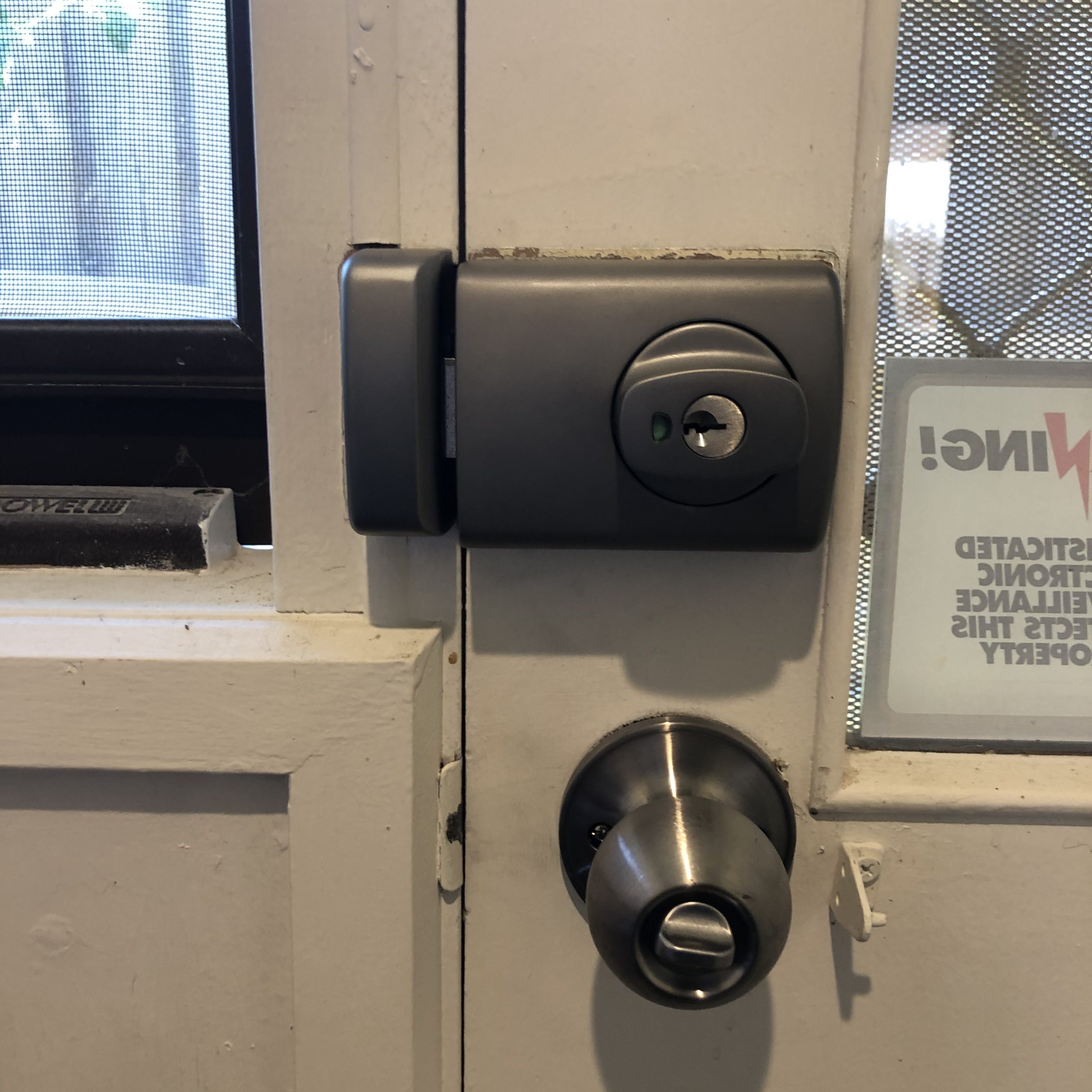 licensed locksmith Melbourne checking door lock professionally