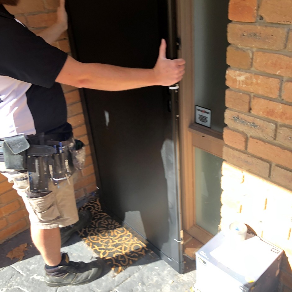 Locksmith adjusting door alignment and strike plate in Mitcham home
