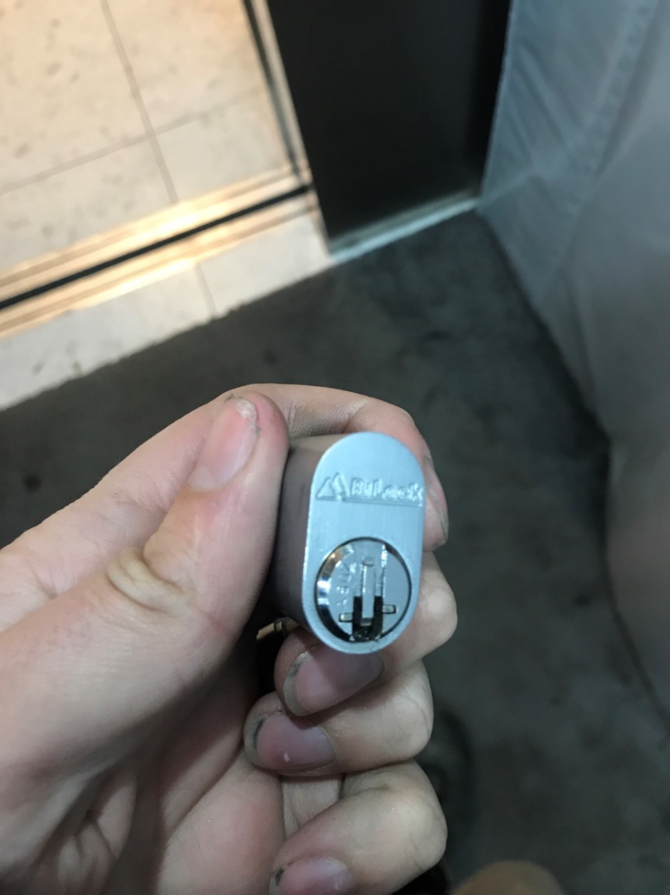 Locksmith rekeying door lock cylinder in Blackburn home